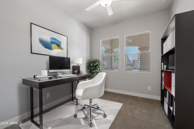 carpeted office space with ceiling fan