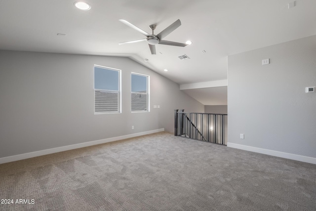 empty room with carpet flooring, ceiling fan, and vaulted ceiling