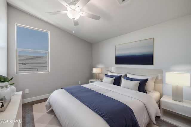 carpeted bedroom featuring ceiling fan and vaulted ceiling