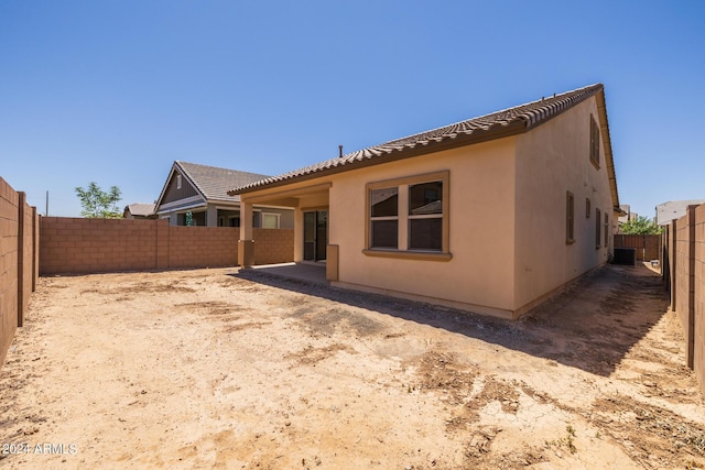 rear view of house featuring cooling unit