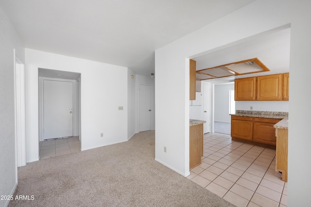 unfurnished living room featuring light colored carpet and light tile patterned floors