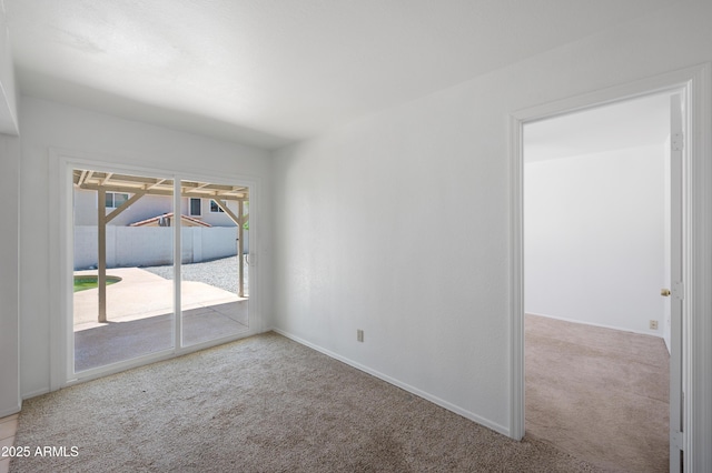 spare room with carpet and baseboards