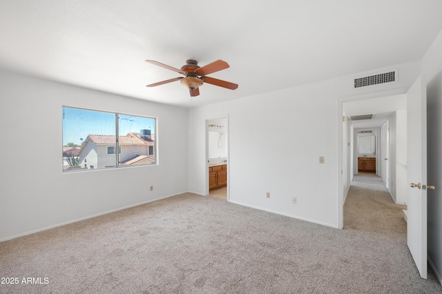 unfurnished bedroom featuring light colored carpet, baseboards, and visible vents