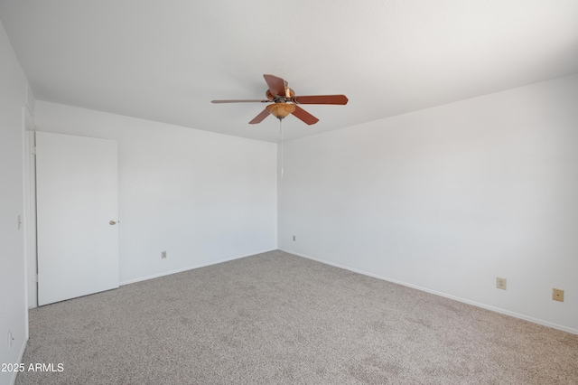 spare room with carpet flooring, baseboards, and a ceiling fan