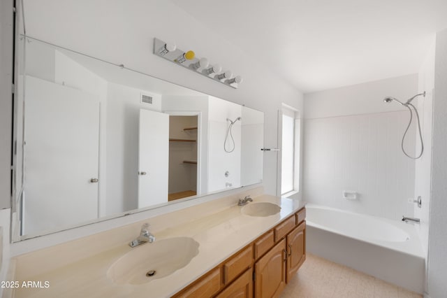 full bathroom with double vanity, shower / washtub combination, visible vents, and a sink