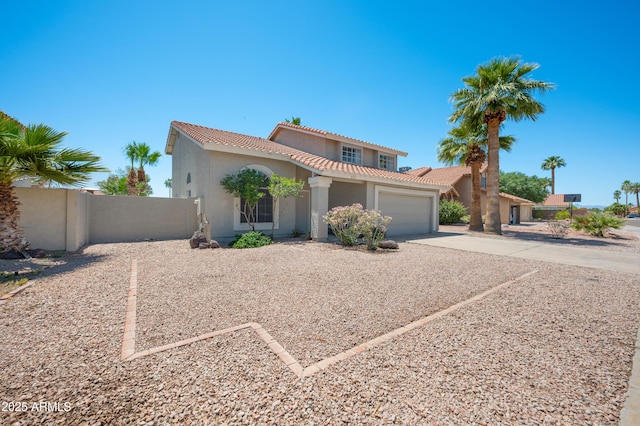 mediterranean / spanish-style house featuring a garage, stucco siding, a tile roof, fence, and concrete driveway