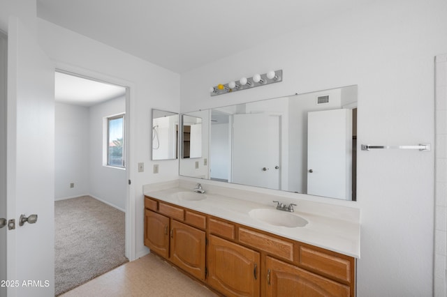 full bathroom featuring a sink, double vanity, visible vents, and tile patterned floors