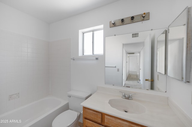 bathroom with vanity, toilet, and visible vents