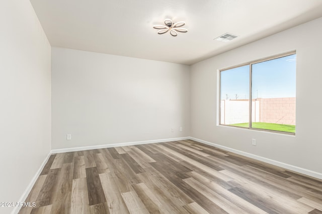 empty room with hardwood / wood-style floors