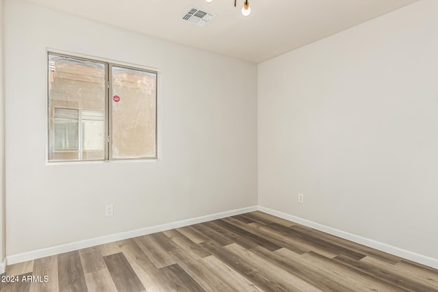 spare room with hardwood / wood-style floors