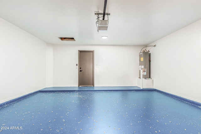 garage featuring electric water heater and a garage door opener