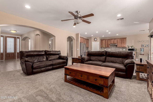 living room with light tile patterned floors and ceiling fan