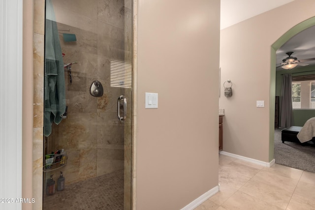 bathroom featuring vanity, a shower with shower door, tile patterned floors, and ceiling fan