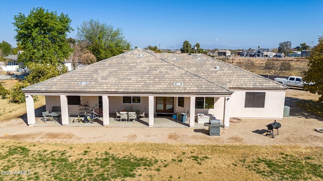 back of house featuring central AC unit and a patio