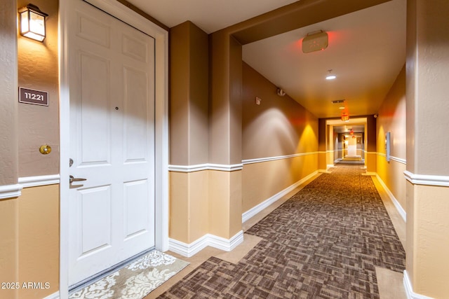 hall with visible vents and baseboards