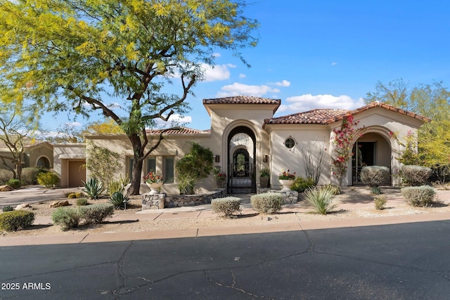 mediterranean / spanish-style house featuring a garage