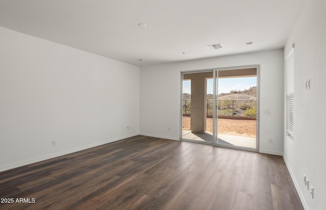 32076 N 136th Ave, Peoria, AZ 85383 - unfurnished room with baseboards, visible vents, and dark wood-type flooring