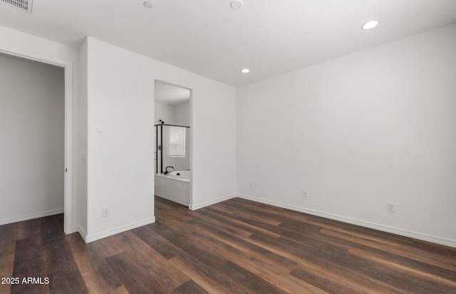 32076 N 136th Ave, Peoria, AZ 85383 - unfurnished bedroom featuring ensuite bathroom, dark wood-style flooring, visible vents, baseboards, and recessed lighting