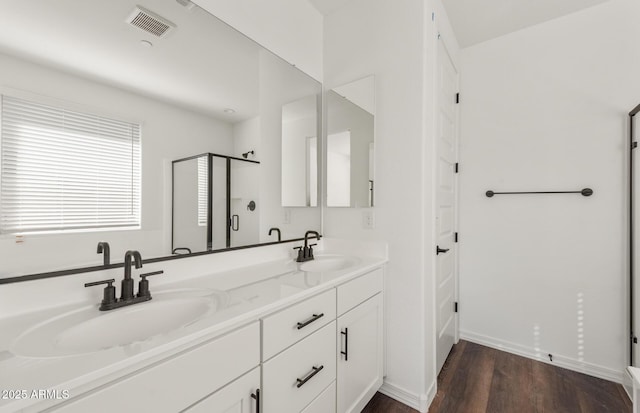 32076 N 136th Ave, Peoria, AZ 85383 - full bath with visible vents, a sink, a stall shower, and wood finished floors