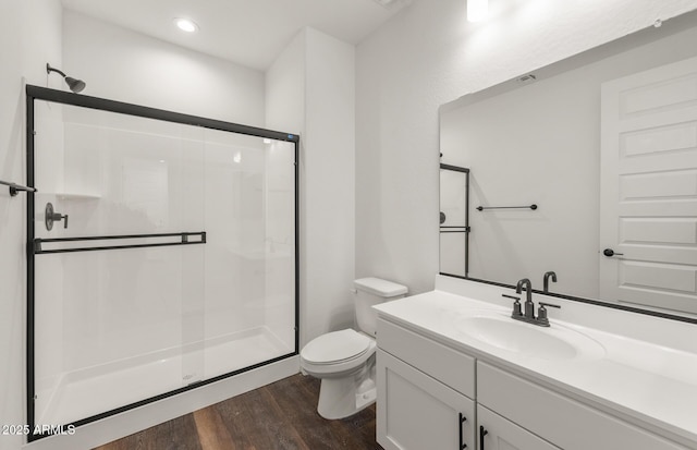 32076 N 136th Ave, Peoria, AZ 85383 - bathroom with a stall shower, toilet, vanity, wood finished floors, and recessed lighting