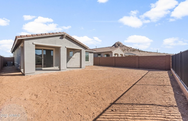 32076 N 136th Ave, Peoria, AZ 85383 - back of property featuring stucco siding, a fenced backyard, a tiled roof, and a patio area