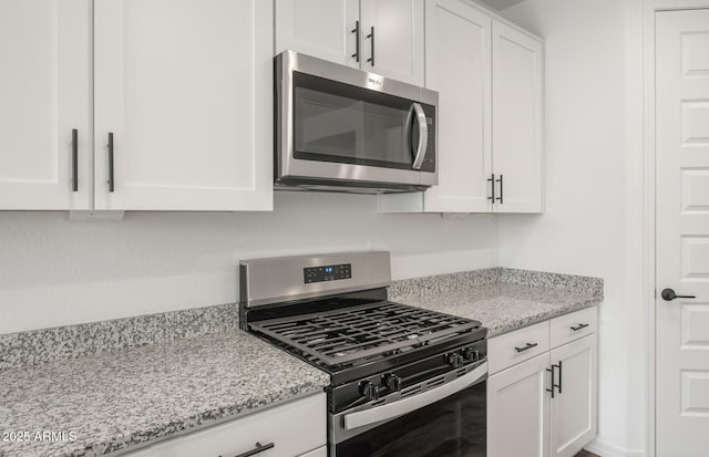 32076 N 136th Ave, Peoria, AZ 85383 - kitchen with white cabinetry, light stone countertops, and stainless steel appliances