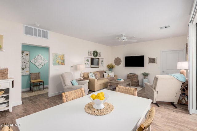 dining space featuring light hardwood / wood-style floors and ceiling fan