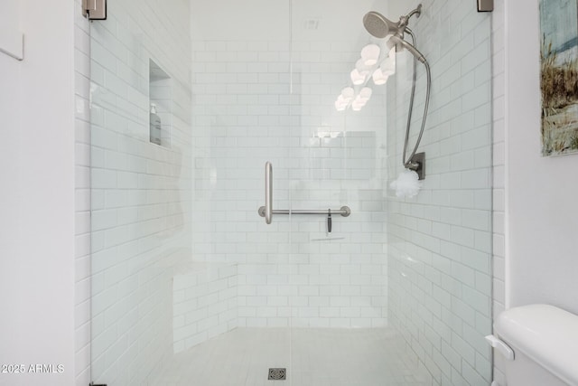 bathroom with toilet and an enclosed shower