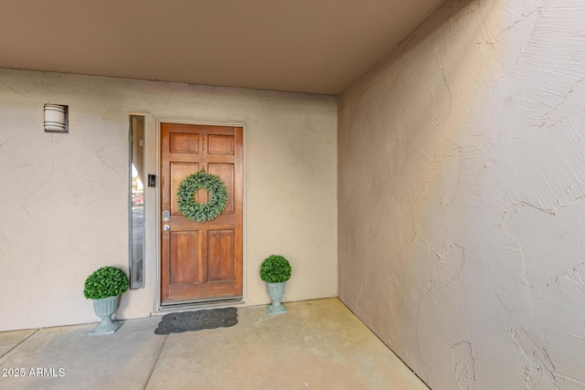 property entrance featuring stucco siding