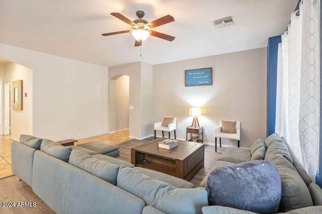 living room with ceiling fan and light hardwood / wood-style flooring