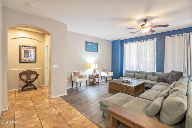 living room with ceiling fan and light hardwood / wood-style floors