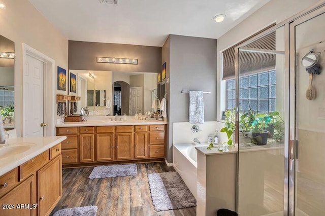 bathroom with vanity, hardwood / wood-style floors, and separate shower and tub