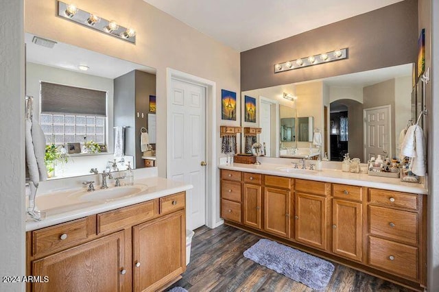 bathroom with vanity and hardwood / wood-style floors