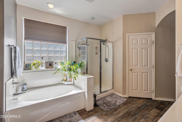 bathroom featuring hardwood / wood-style flooring and independent shower and bath