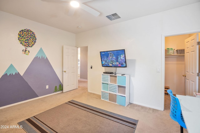 carpeted bedroom with a closet and ceiling fan