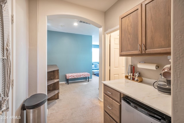 kitchen featuring light colored carpet and stainless steel dishwasher