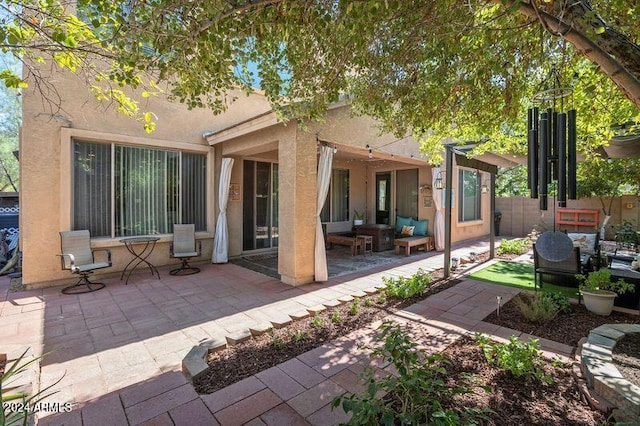 rear view of house with outdoor lounge area and a patio area