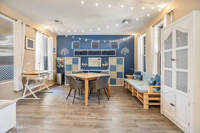 dining space with light hardwood / wood-style flooring