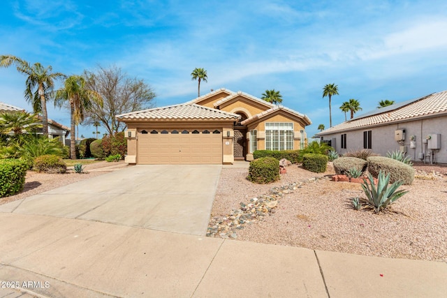 view of front facade featuring a garage, a tiled roof, concrete driveway, and stucco siding