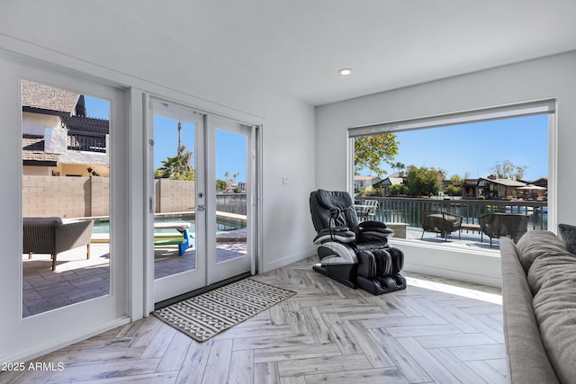 living area with recessed lighting, baseboards, and french doors