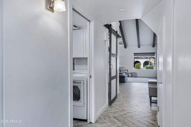 corridor featuring washer / clothes dryer, beam ceiling, and a barn door