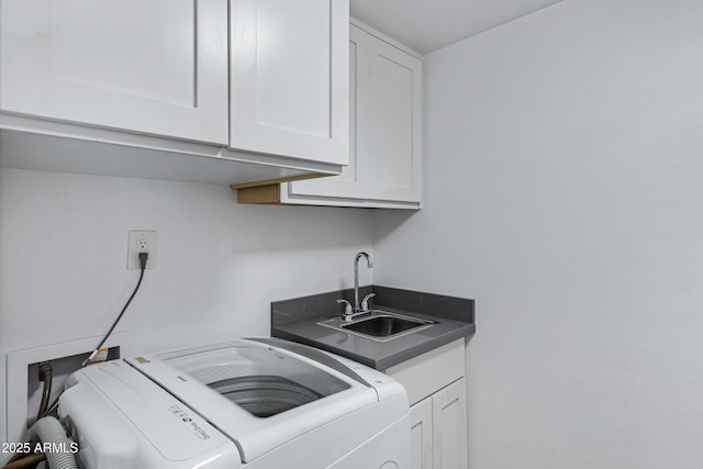 laundry room with cabinet space, washer and clothes dryer, and a sink