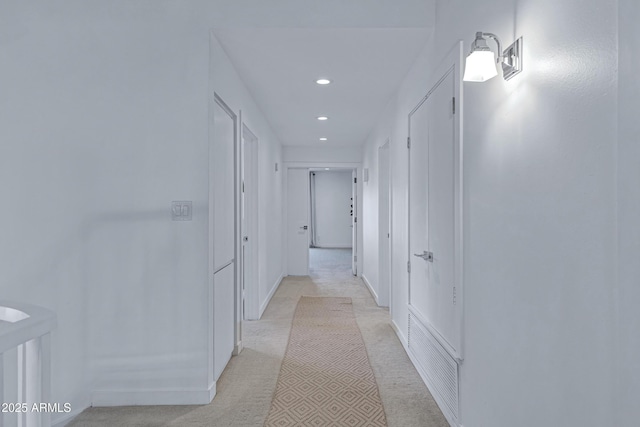 hallway with recessed lighting, visible vents, and baseboards