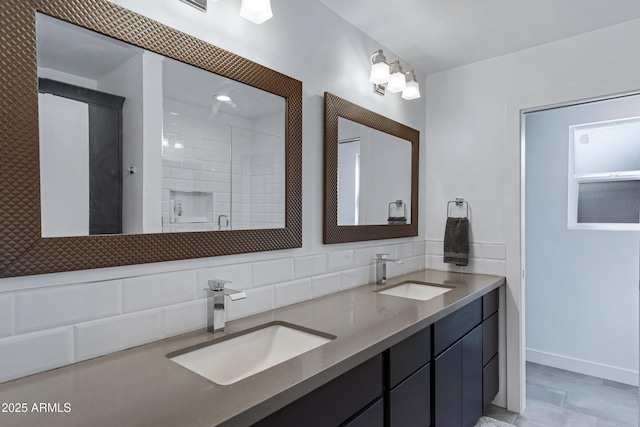 bathroom featuring double vanity, a stall shower, decorative backsplash, and a sink