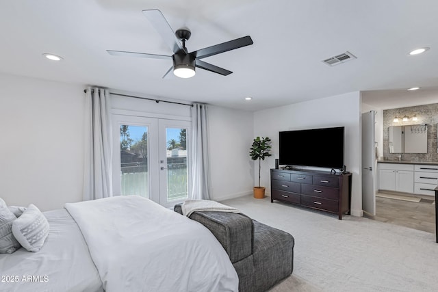 bedroom with light colored carpet, recessed lighting, and visible vents