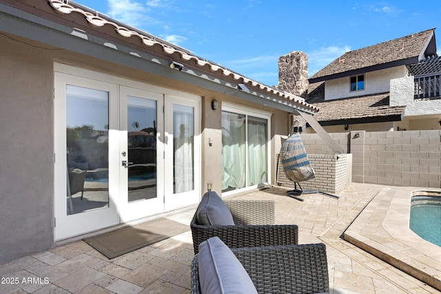 view of patio / terrace with fence and french doors