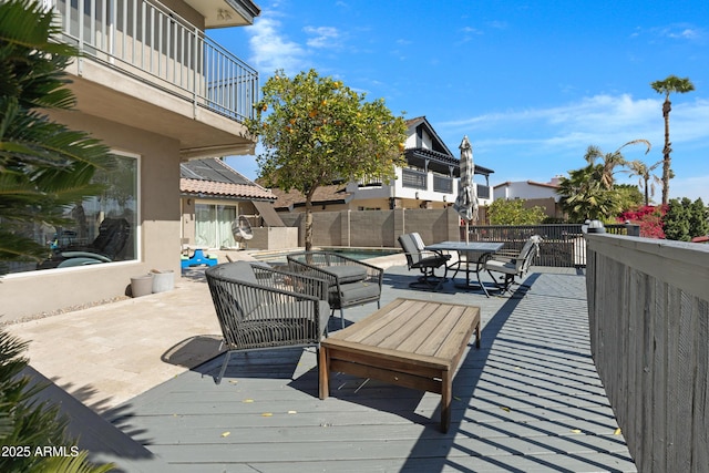 deck featuring outdoor dining area and a fenced backyard