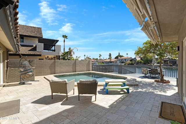 view of swimming pool featuring a fenced in pool, a fenced backyard, and a patio