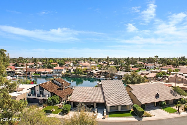 birds eye view of property with a water view and a residential view