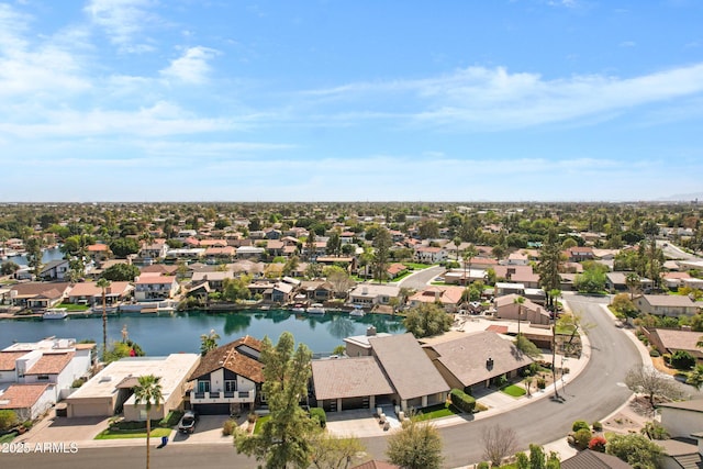 drone / aerial view featuring a water view and a residential view